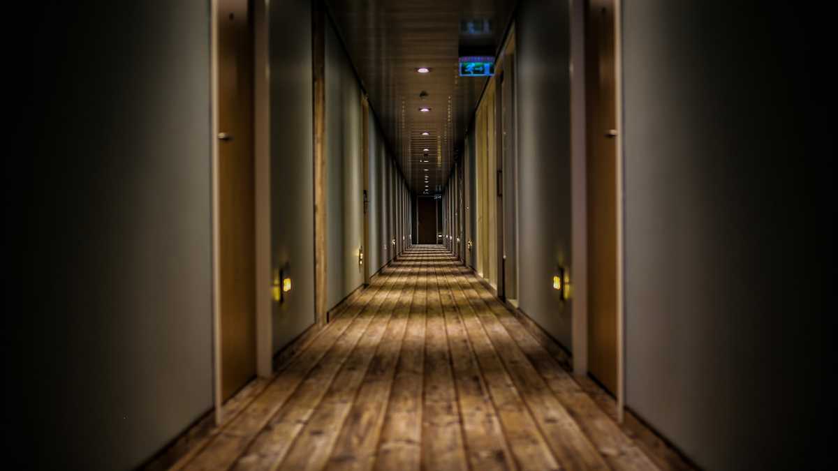 A clean, empty treatment room with a reclining chair and soft lighting