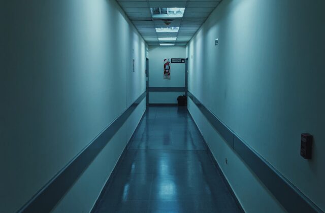 A quiet hospital corridor with white walls