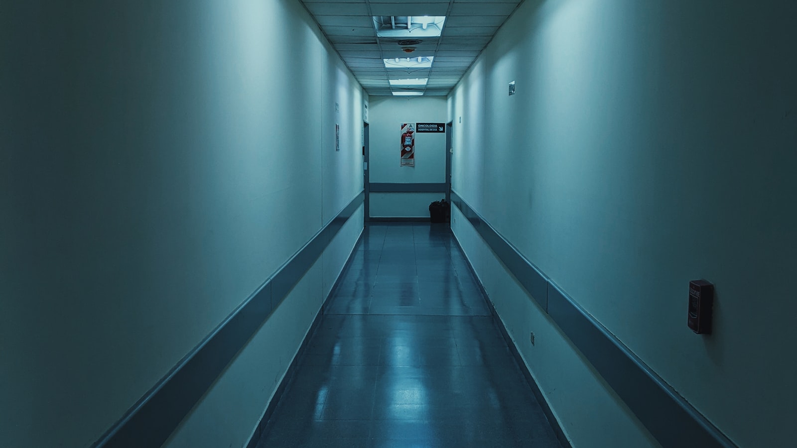 A quiet hospital corridor with white walls