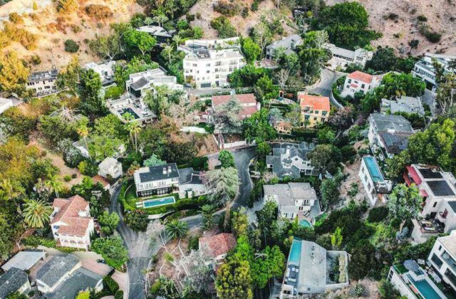 Quiet residential street in West Hills with hillside homes, mature trees and parked cars